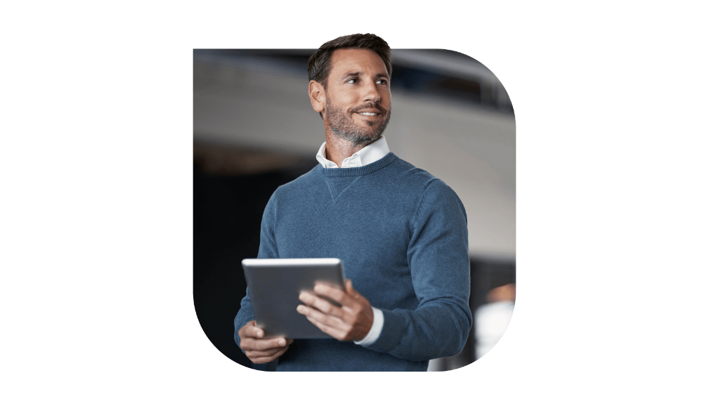 A gentleman gazing sideways holding a tablet