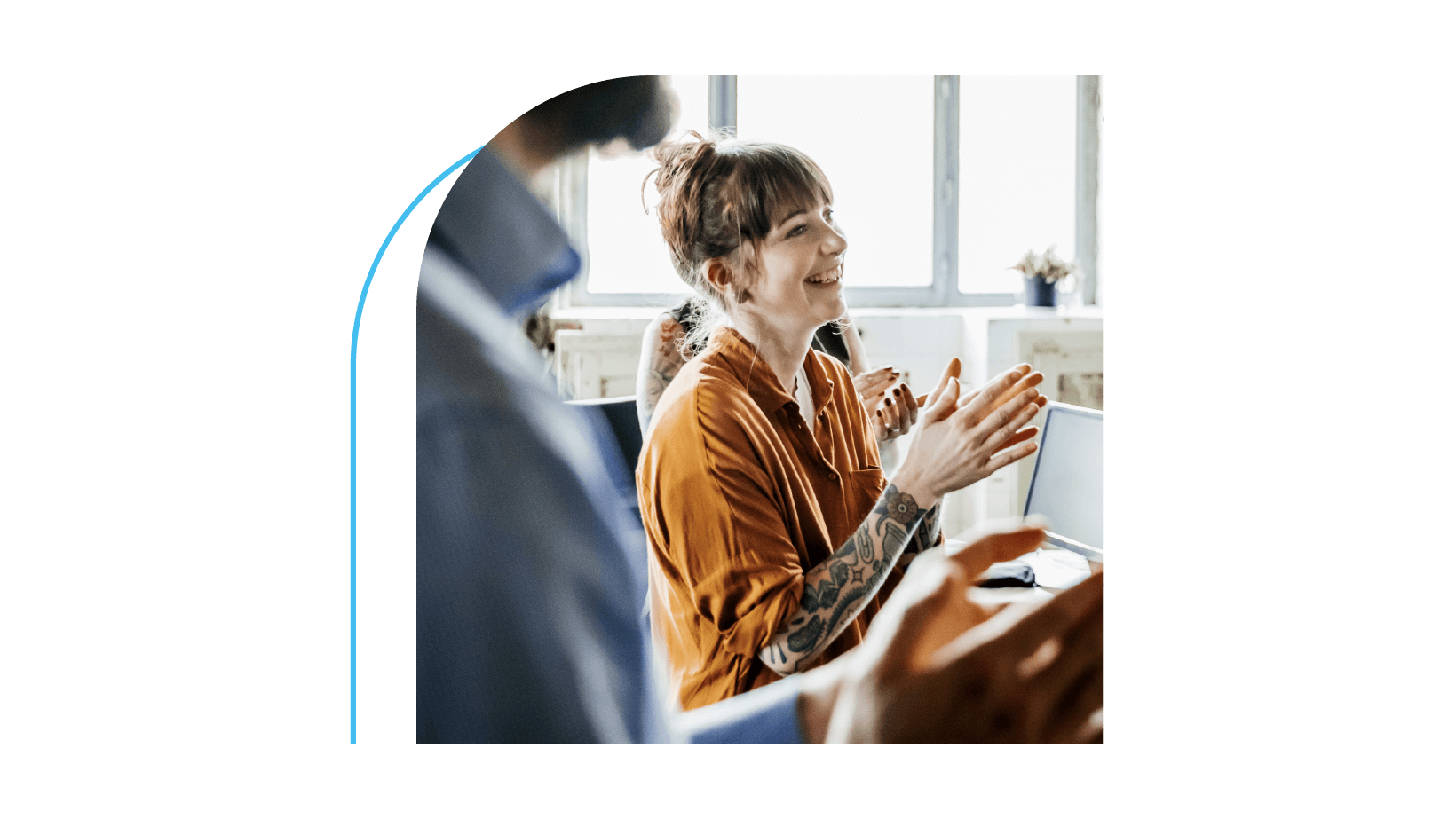 A group of happy employees clapping and smiling